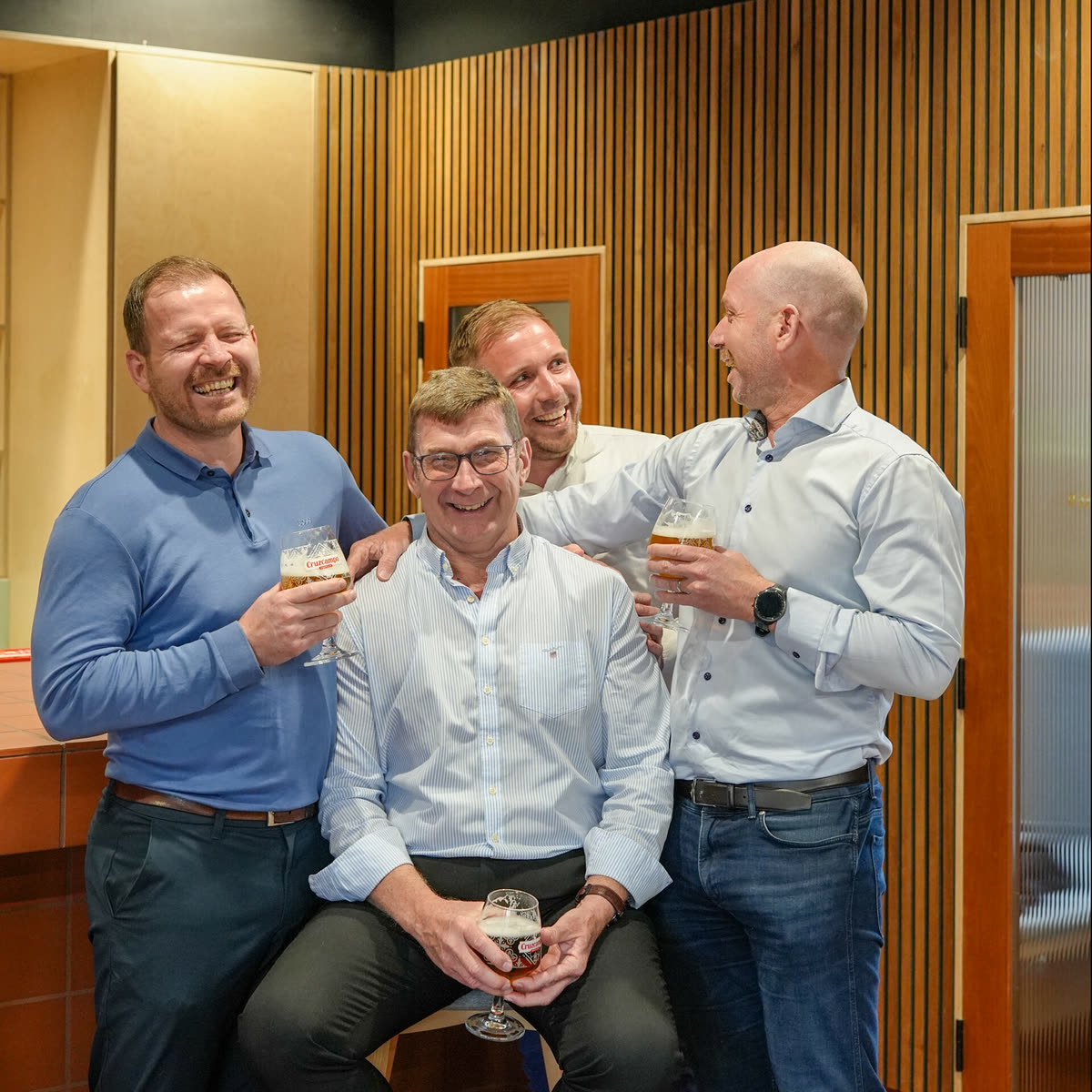 Four men of the Hooper-Nash family together, laughing, drinks in hand